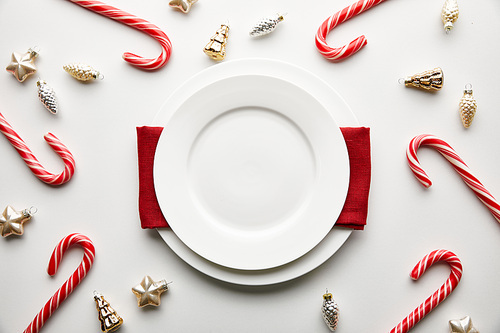top view of festive Christmas table setting on white background with decoration and candies