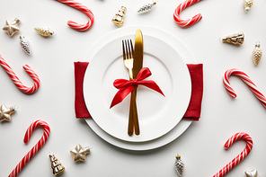 top view of festive Christmas table setting on white background with decoration and candies