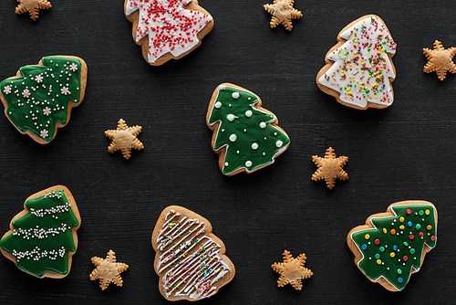 delicious glazed Christmas cookies on black background