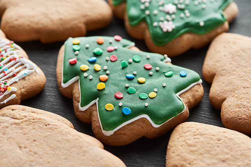 close up view of delicious glazed Christmas tree cookies