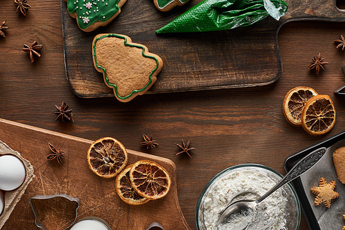 top view of Christmas cookies preparation on wooden table