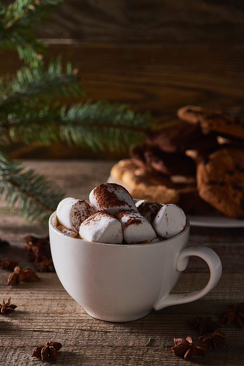 selective focus of Christmas cacao with marshmallow on wooden table