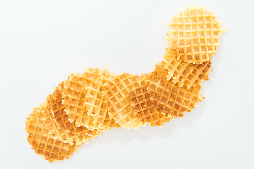 top view of tasty and crispy waffles on white