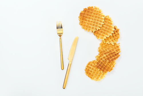 top view of waffles and fork with knife isolated on white