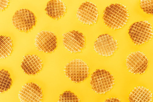 top view of crispy waffles isolated on yellow