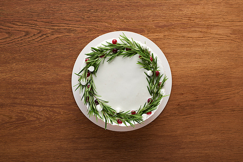 top view of traditional christmas pie with rosemary and cranberries on wooden table
