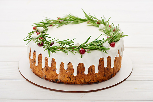 christmas pie with white rosemary and cranberries on white wooden table