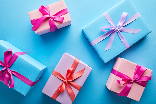 top view of colorful gift boxes on blue background