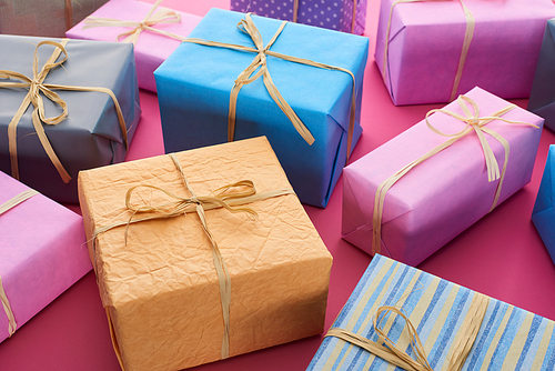 colorful presents with decorative bows on crimson
