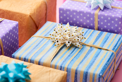 selective focus of stripped present near colorful gifts