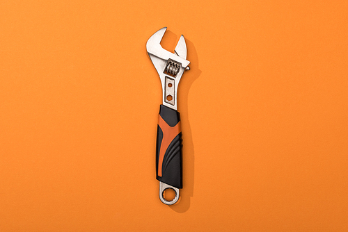 Top view of wrench on orange background