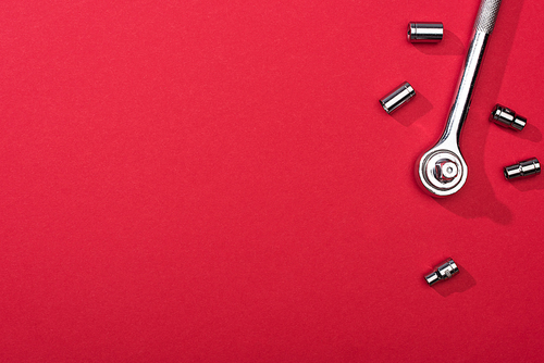 Top view of wrench with nozzles on red background