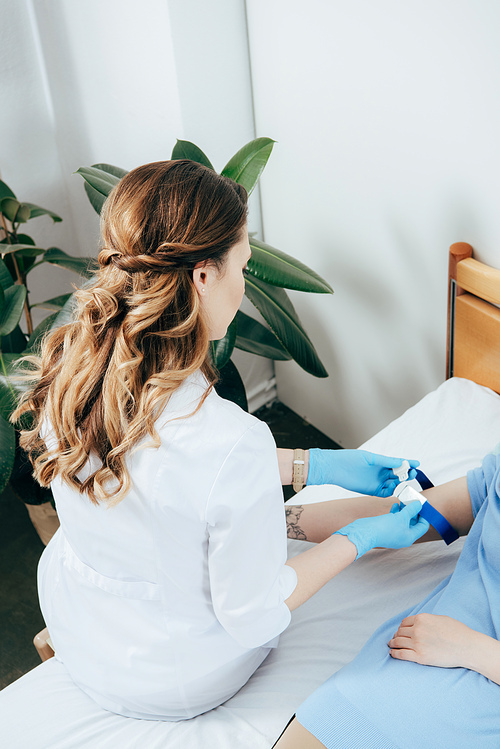 doctor preparing donor for blood donation in clinic