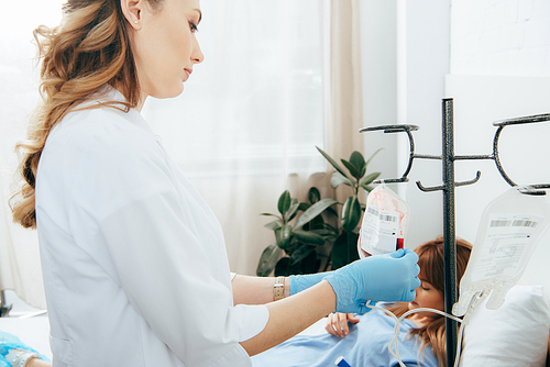 donor and doctor in white coat with blood bag in clinic