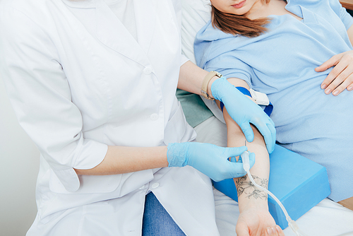 cropped view of doctor in latex gloves doing injection in hospital