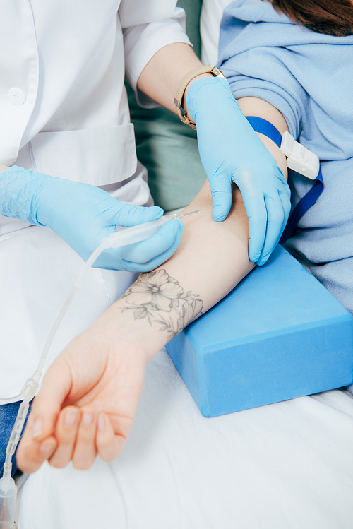 cropped view of doctor in latex gloves doing injection in hospital