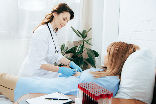 doctor in white coat preparing patient for injection