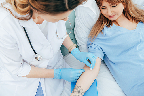 cropped view of doctor preparing donor for blood donation