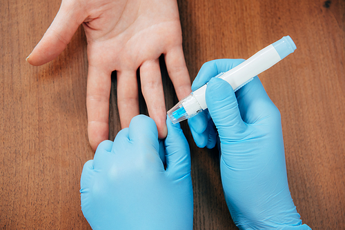 cropped view of donor and doctor obtaining blood sample