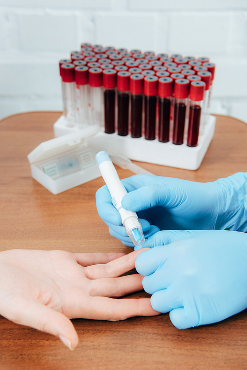 cropped view of donor and doctor obtaining blood sample