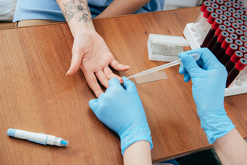 cropped view of donor and doctor obtaining blood sample