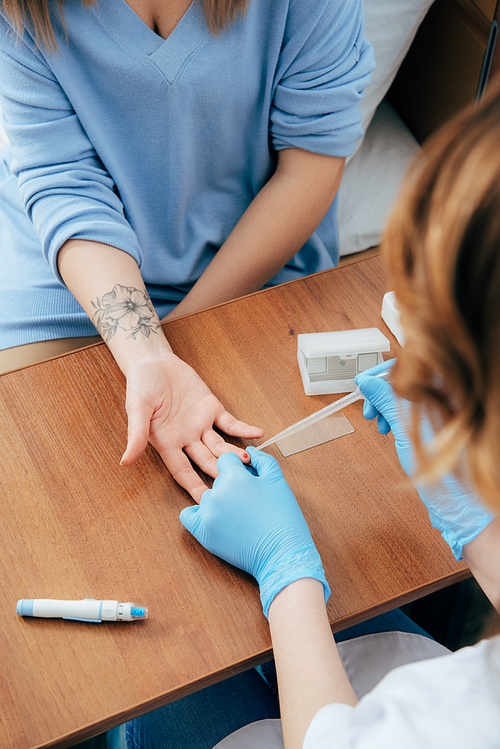 cropped view of donor and doctor obtaining blood sample