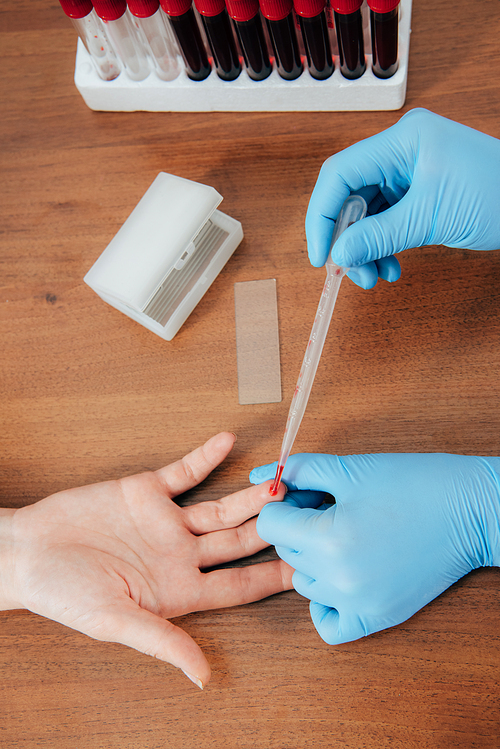 cropped view of donor and doctor obtaining blood sample