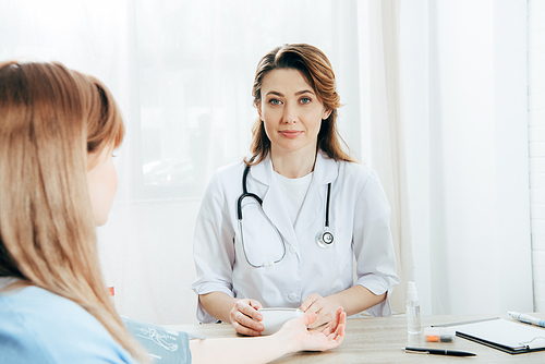 cropped view of patient and doctor measuring blood pressure