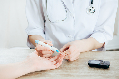 cropped view of donor and doctor obtaining blood sample