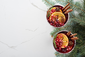 top view of christmas cocktails with orange, pomegranate, cinnamon