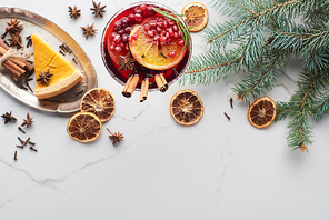 top view of christmas cocktail with orange, pomegranate, cinnamon and pie on tray