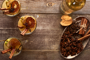 top view of traditional pear mulled wine with spices on wooden rustic table