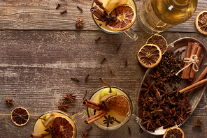 top view of traditional pear mulled wine with spices on wooden rustic table