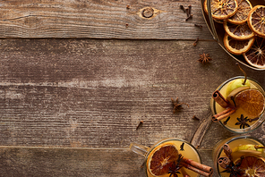 top view of traditional pear mulled wine with spices on wooden rustic table with copy space