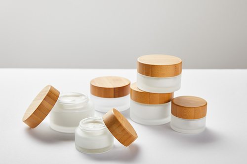 plenty of glass jars with wooden caps on white