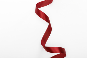 top view of satin burgundy decorative curved ribbon isolated on white