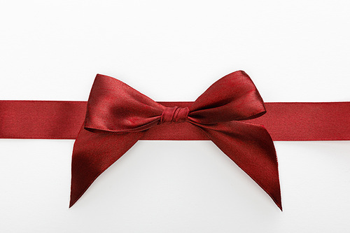 top view of satin burgundy decorative ribbon with bow isolated on white