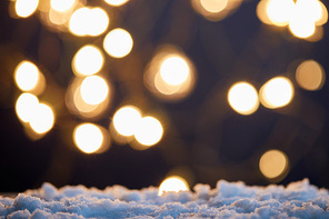 background with blurred christmas lights and snow