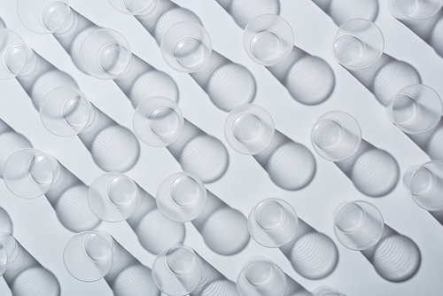 top view of disposable empty cups on white background with shadows