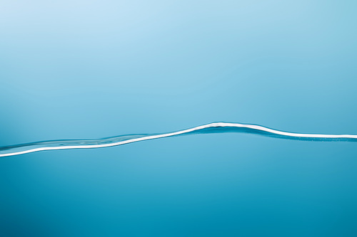 smooth calm transparent pure water on blue background