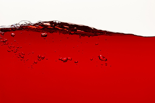 wavy red bright liquid with bubbles isolated on white