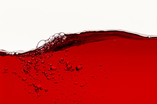red bright liquid with wave and bubbles isolated on white