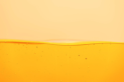 yellow bright liquid with underwater bubbles isolated on yellow