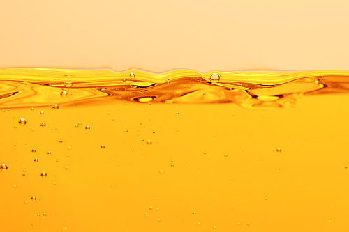 ripple yellow bright liquid with bubbles isolated on yellow