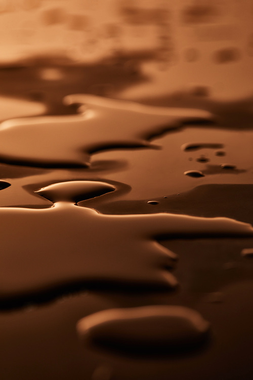 water puddles and drops on brown surface