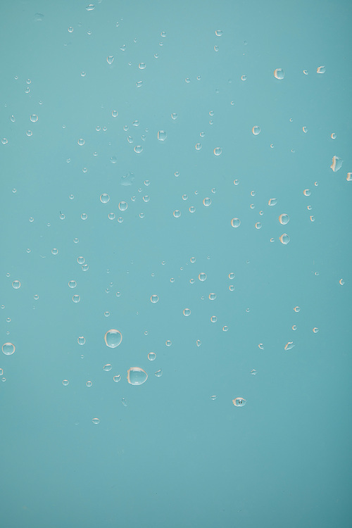 clear water drops on blue background