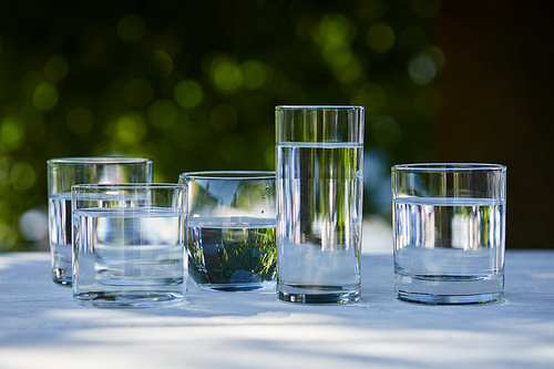 clear fresh water in transparent glasses in sunlight
