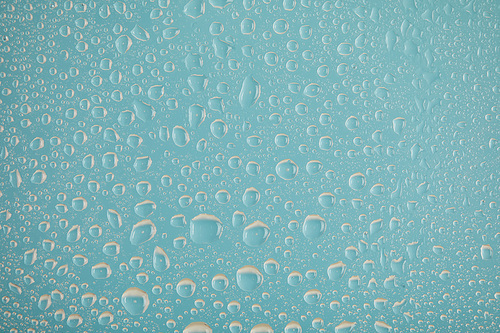 clear transparent water drops on blue background