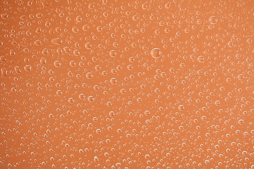 clear transparent water drops on beige background