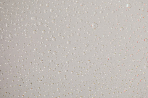 clear transparent water drops on grey background